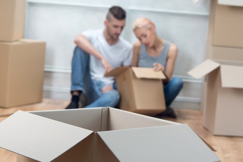 Movers carrying furniture through a narrow flat staircase